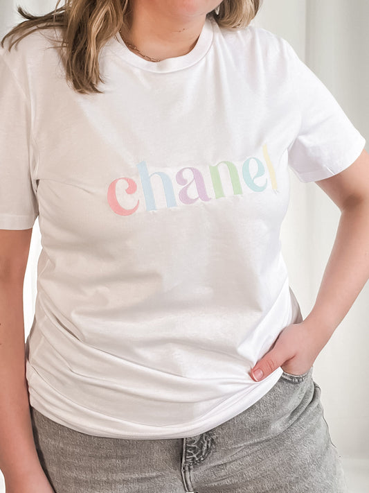 white t-shirt with fruit pastel embroidered design out the purse