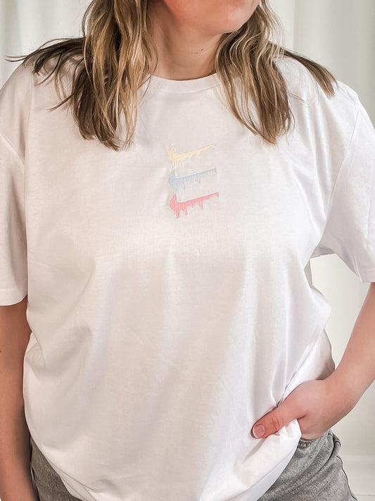 white t-shirt with pastel paint spill embroidered design out the purse